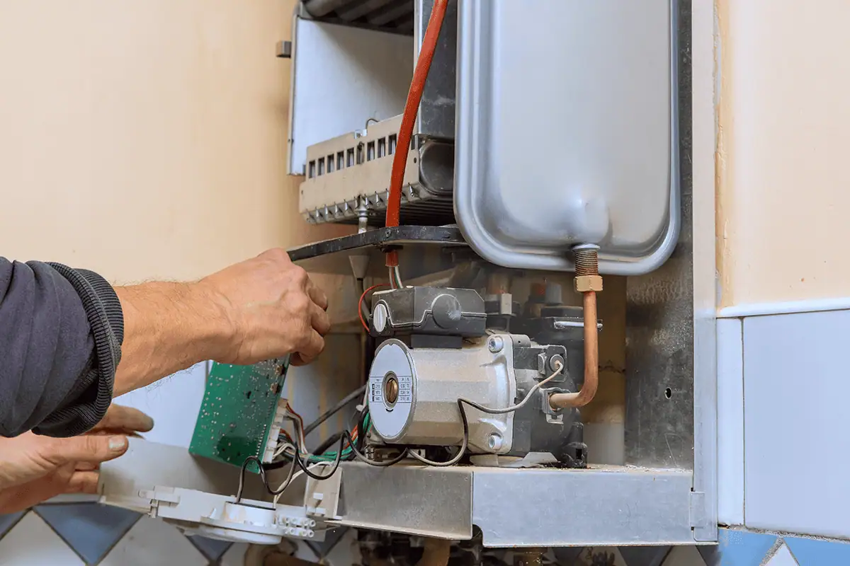Photo showing our Croydon boiler repair heating engineer repairing a boiler in Croydon